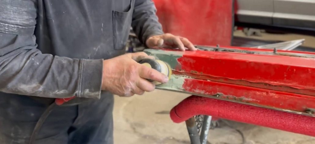 Steve Wepp applying a cosmetic rust patch to a 1966 Mustang door