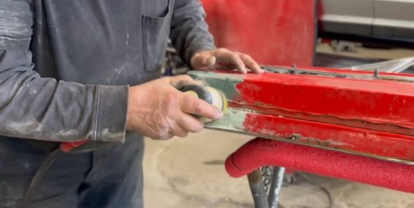 Steve Wepp applying a cosmetic rust patch to a 1966 Mustang door
