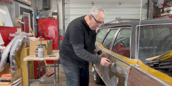 Steve Wepp painting a woodgrain pattern on a 1972 Mercury Colony Park