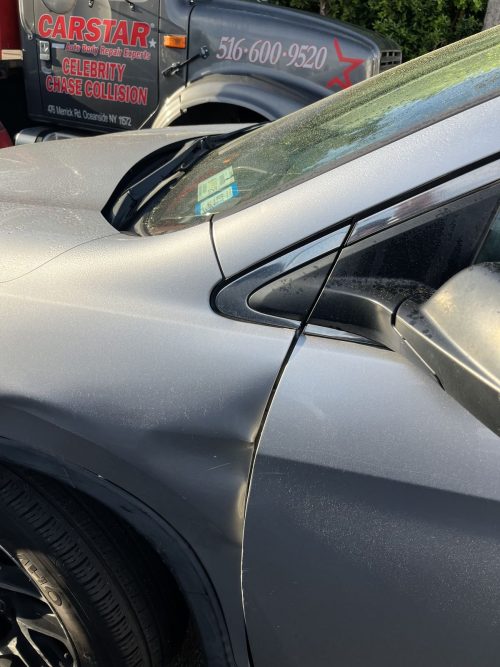 Dent in a car door panel ready for repair