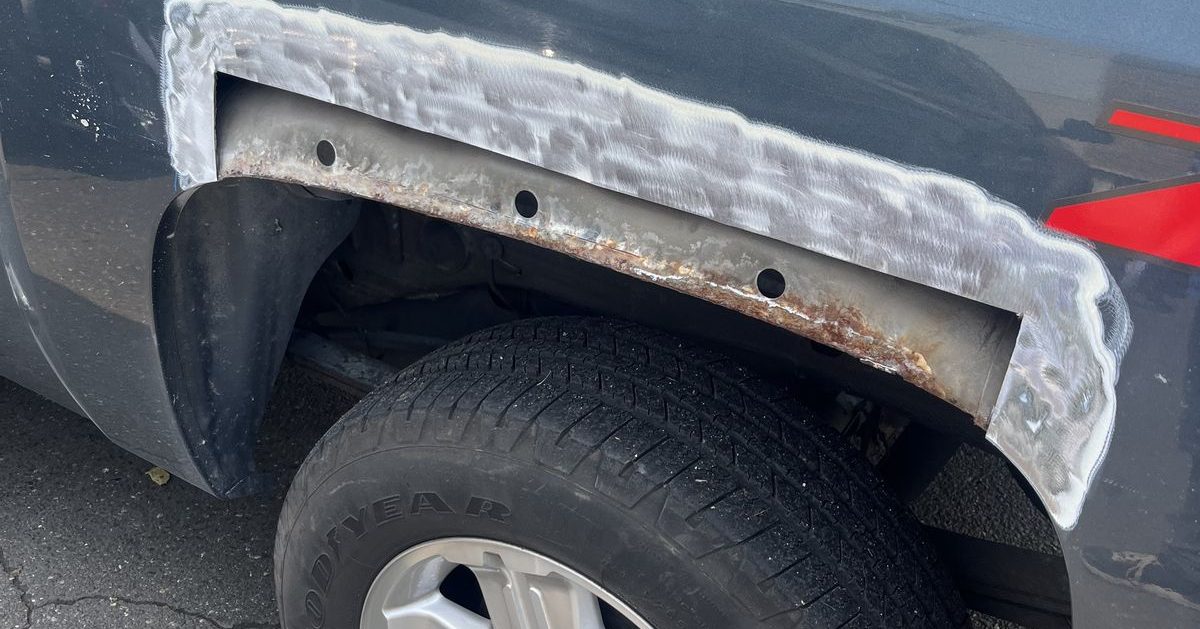 Rusted wheel arch cut back for a patch panel