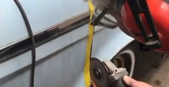 Man cutting a Rambler’s metal body with a rotating cutting disc for a custom office desk